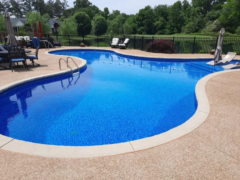 Freeform Las Olas pool in a fenced in backyard