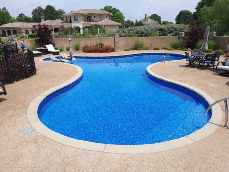 Freeform Las Olas pool in a fenced in backyard