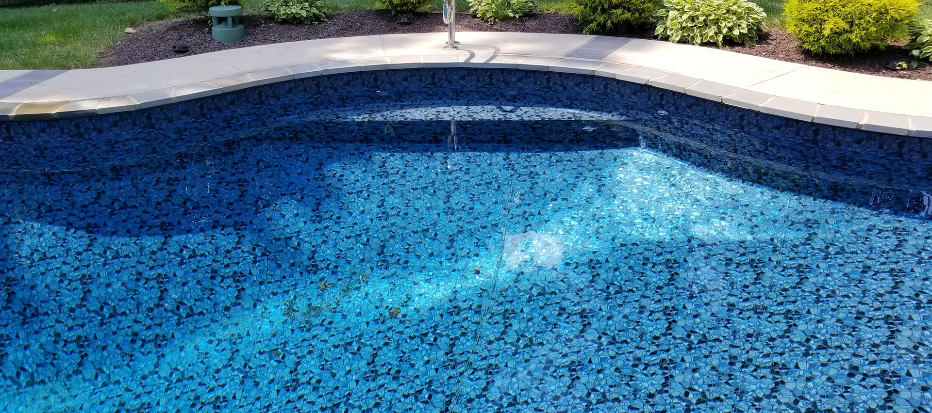 butterfly effect close view of pool water feature and basketball goal