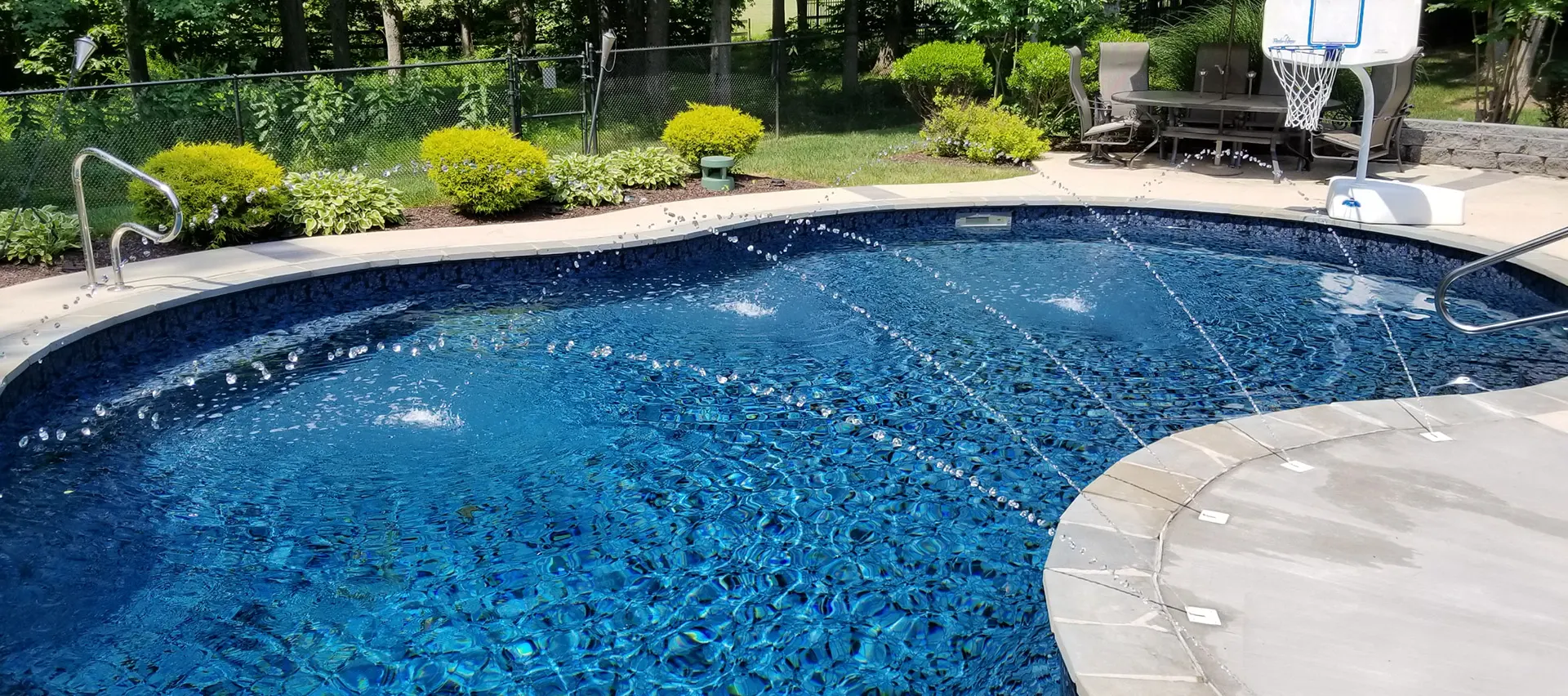 butterfly effect close view of pool water feature and basketball goal