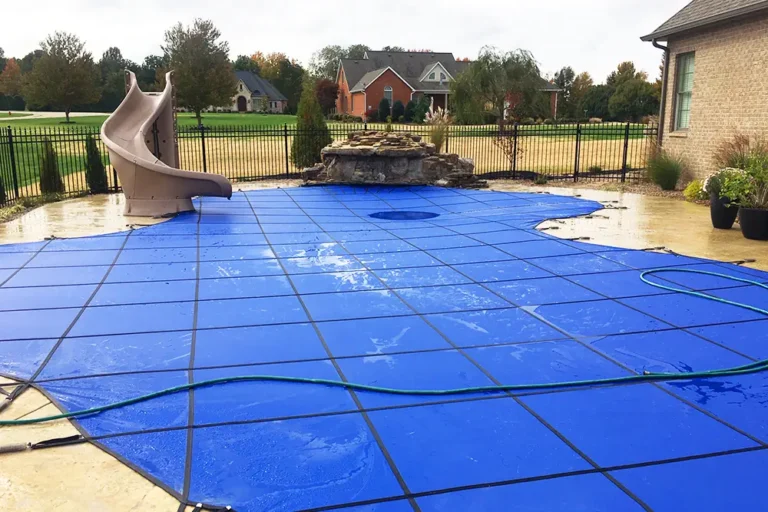 Blue Freeform Pool Cover with Slide and Rock Feature