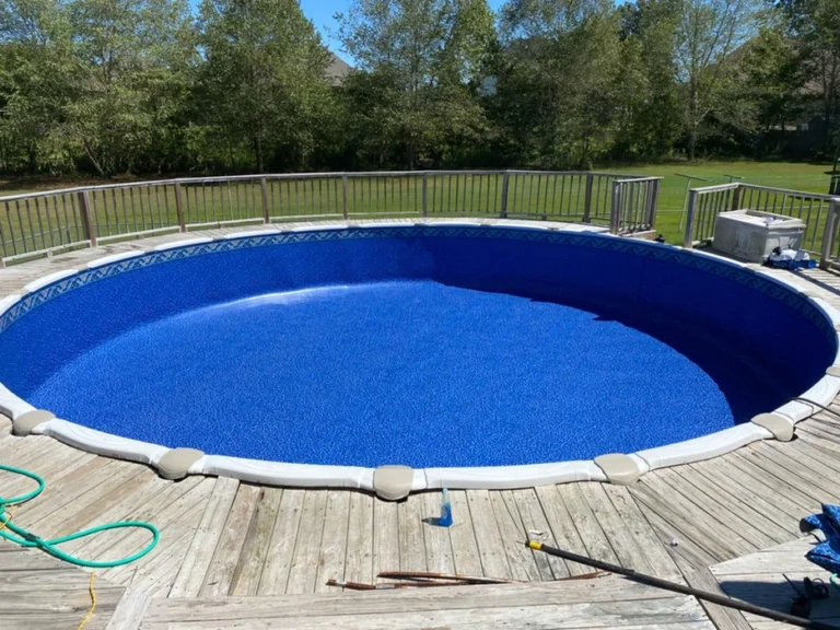 Colorado pattern Above-ground pool with a wooden deck around it