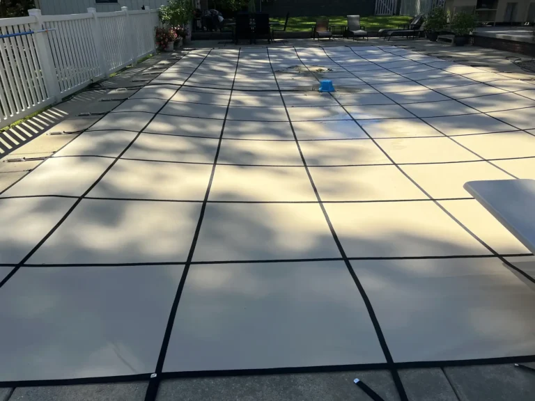 Tan Rectangle Pool Cover with a pump on top