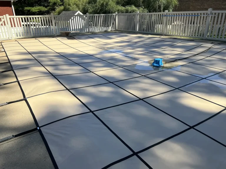 Tan Rectangle Pool Cover with a pump on top