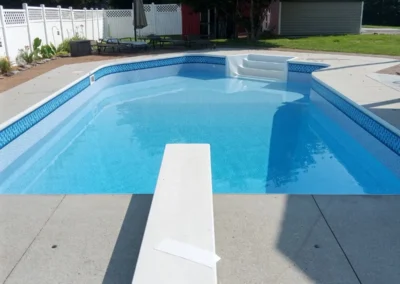 Midas Pool standing behind the diving board