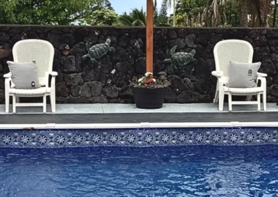Pool chairs next to an pool with the Evening Star Liner