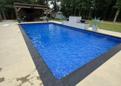 corner view of a sports pool with the Santorini All Over liner with water